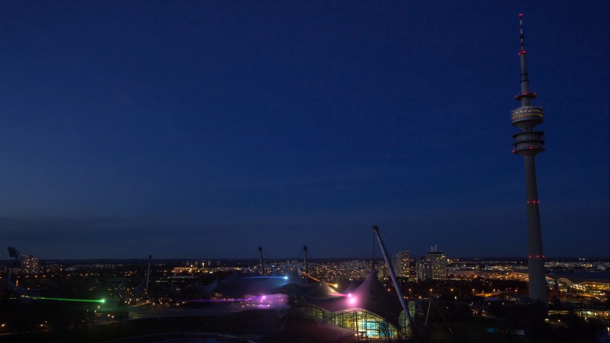 Olympiapark in munich with lights flying over it